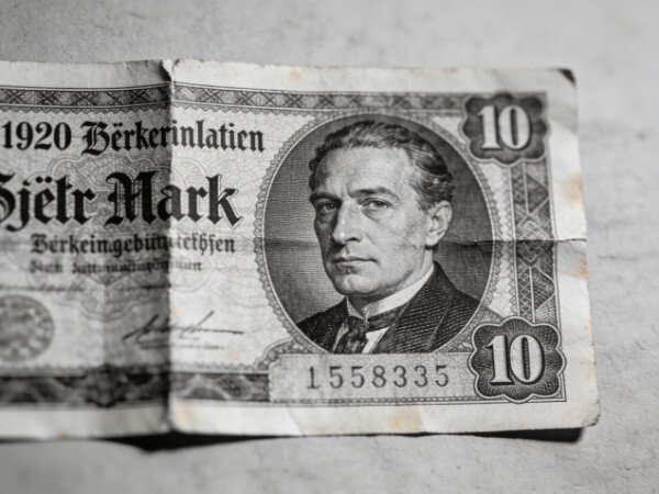 A close-up of a historical fiat currency, the German Mark from the 1920s, in black and white.